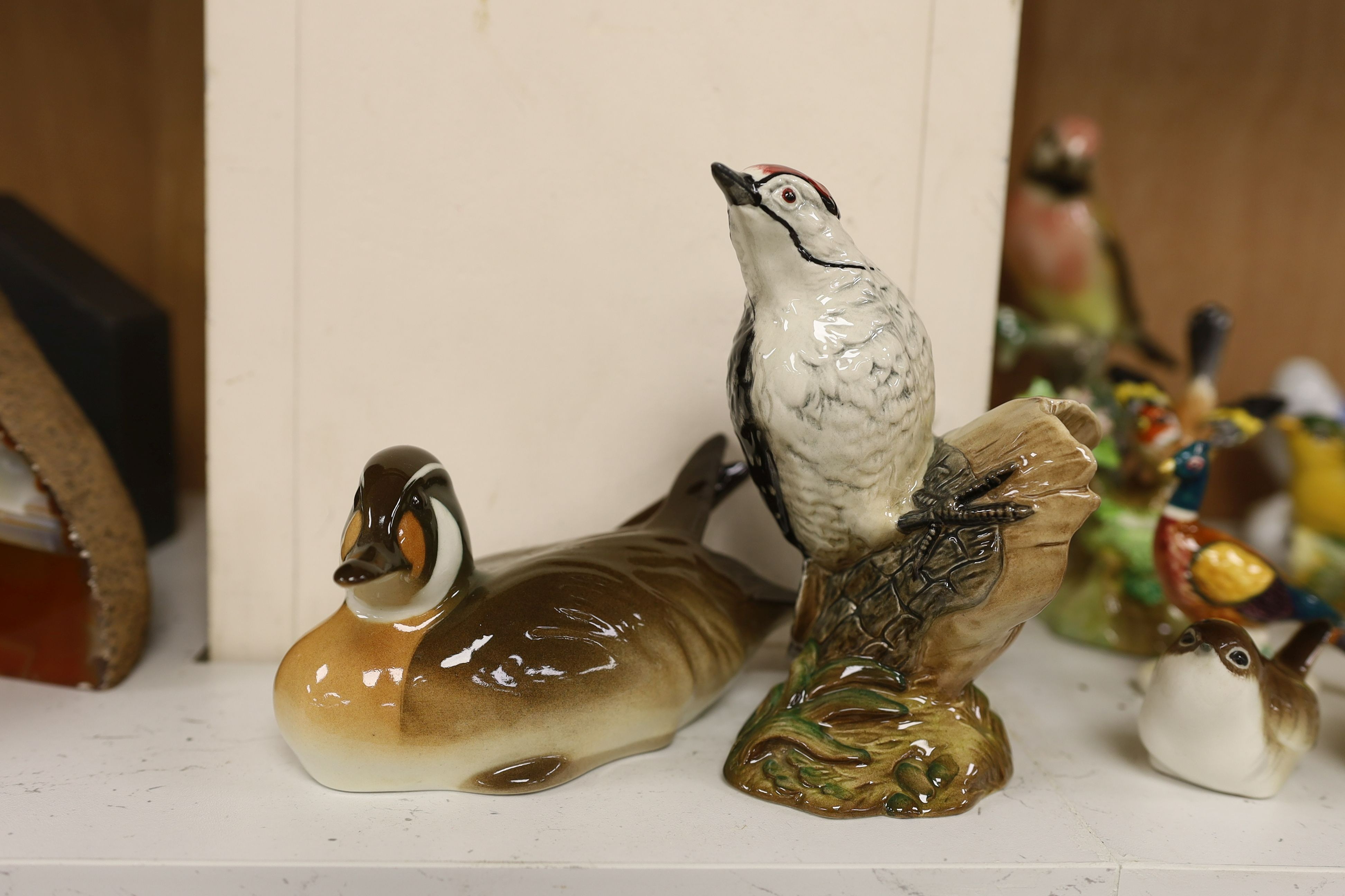 A large collection of ceramic bird figures including Beswick, Russian models, Karl Ens etc